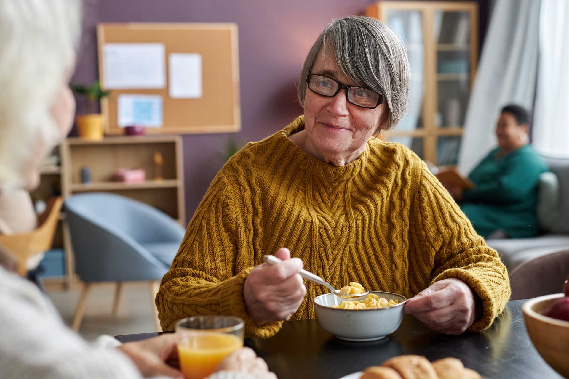two women having breakfast at a table